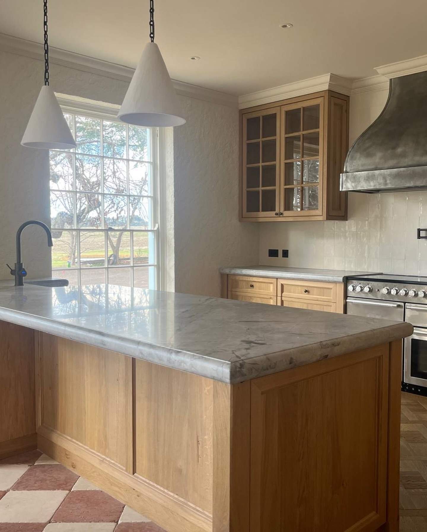Country kitchen with timber island and marble bench