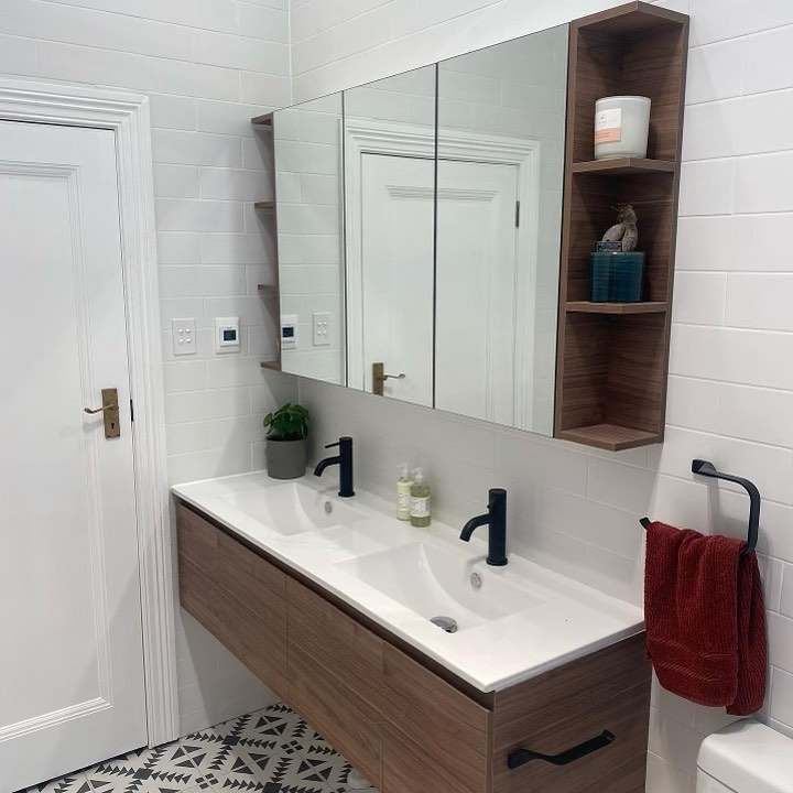 The finished bathroom: timber vanity with double basin, mirror cabinet and modular timber shelving
