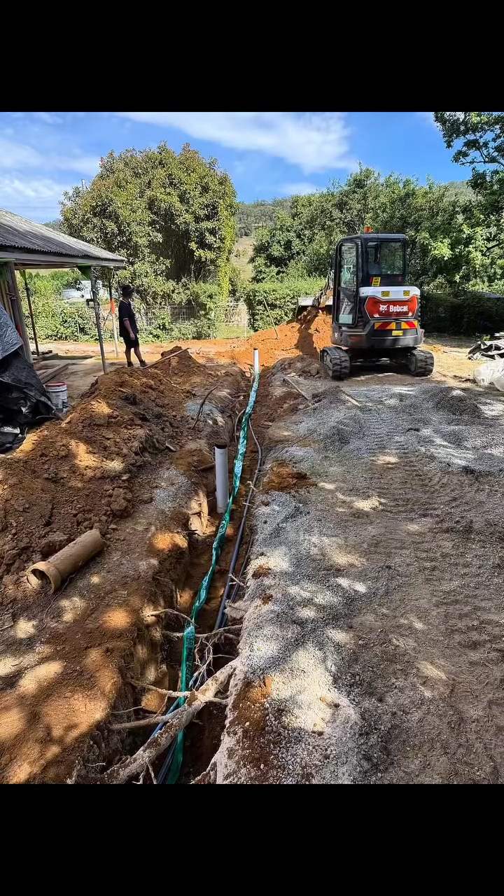 Excavator on the harbour — Trenching for stormwater and sewer